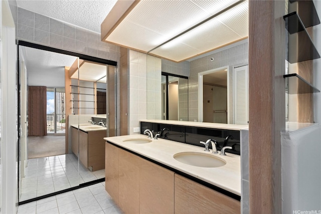 1212 Nuuanu Ave Unit 1104, Honolulu, HI 96817 - bathroom featuring tile patterned floors, double vanity, and tile walls