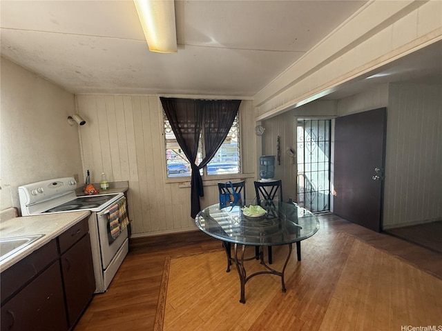 91-1337 Karayan St, Ewa Beach, HI 96706 - kitchen featuring electric range, wood finished floors, light countertops, dark brown cabinetry, and wooden walls