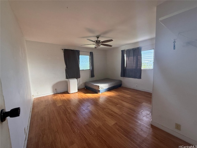 91-1337 Karayan St, Ewa Beach, HI 96706 - unfurnished bedroom with multiple windows, wood finished floors, and ceiling fan