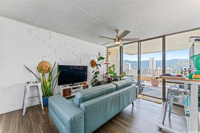 2121 Ala Wai Blvd Unit 2301, Honolulu, HI 96815 - living room featuring a wall of windows, a ceiling fan, a textured ceiling, and wood finished floors