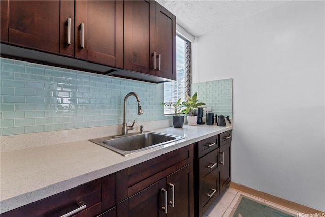 2121 Ala Wai Blvd Unit 2301, Honolulu, HI 96815 - kitchen featuring light countertops, a textured ceiling, decorative backsplash, light tile patterned flooring, and dark brown cabinetry