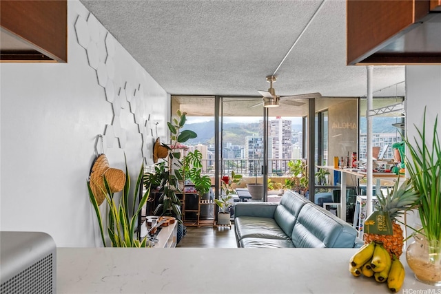 2121 Ala Wai Blvd Unit 2301, Honolulu, HI 96815 - living area with expansive windows, ceiling fan, wood finished floors, and a textured ceiling