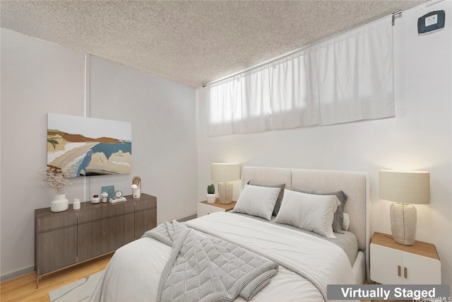 2121 Ala Wai Blvd Unit 2301, Honolulu, HI 96815 - bedroom with a textured ceiling and light wood-style flooring
