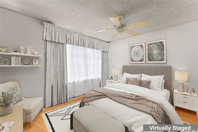 2121 Ala Wai Blvd Unit 2301, Honolulu, HI 96815 - bedroom with a textured ceiling, wood finished floors, and a ceiling fan