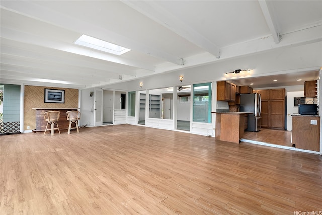 44-151 Bayview Haven Pl, Kaneohe, HI 96744 - unfurnished living room with a skylight, beamed ceiling, and light wood-style flooring