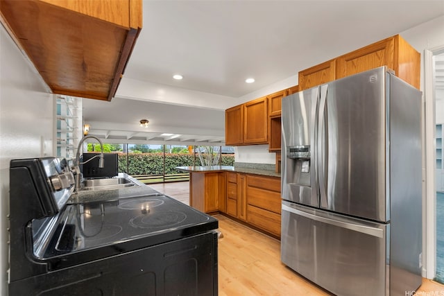 44-151 Bayview Haven Pl, Kaneohe, HI 96744 - kitchen featuring stainless steel fridge, a peninsula, light wood-style floors, brown cabinetry, and black / electric stove