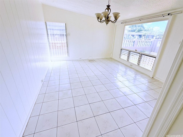 91-1206 Hanaloa St, Ewa Beach, HI 96706 - unfurnished room with a chandelier, light tile patterned floors, and a textured ceiling