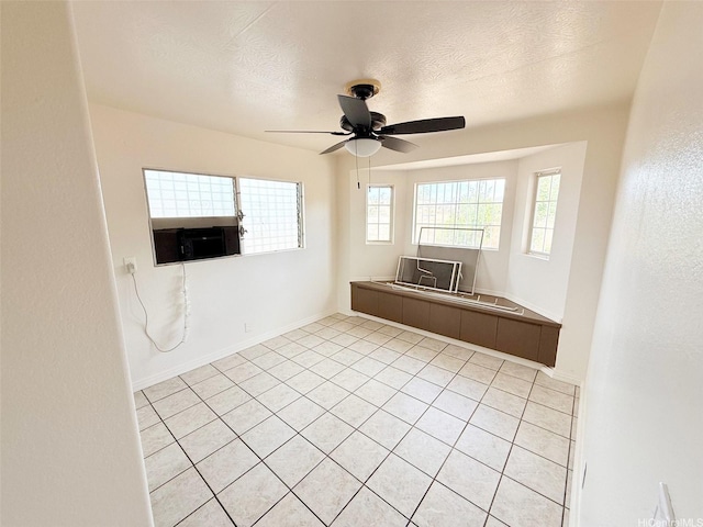 91-1206 Hanaloa St, Ewa Beach, HI 96706 - empty room featuring a ceiling fan, a textured ceiling, and light tile patterned flooring