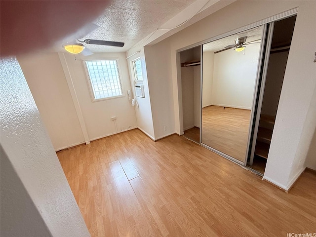 91-1206 Hanaloa St, Ewa Beach, HI 96706 - unfurnished bedroom with light wood-style flooring, a ceiling fan, a closet, a textured ceiling, and cooling unit