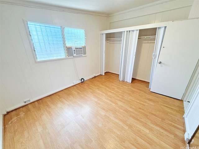 91-1206 Hanaloa St, Ewa Beach, HI 96706 - unfurnished bedroom with cooling unit, light wood-style flooring, ornamental molding, and multiple closets