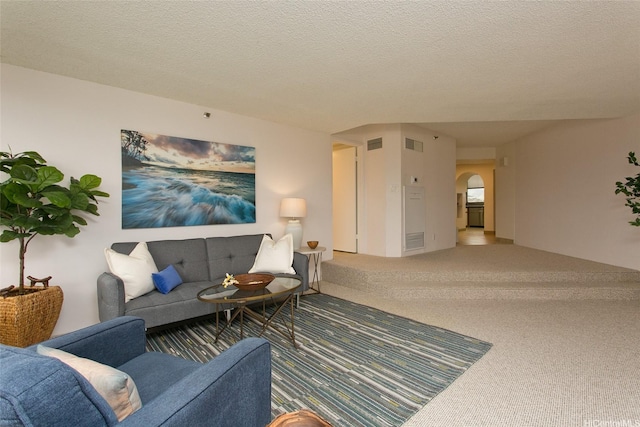 1221 Victoria St Unit 2301, Honolulu, HI 96814 - living area featuring arched walkways, carpet flooring, and a textured ceiling