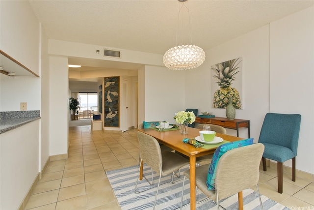 1221 Victoria St Unit 2301, Honolulu, HI 96814 - dining area with light tile patterned floors and a chandelier