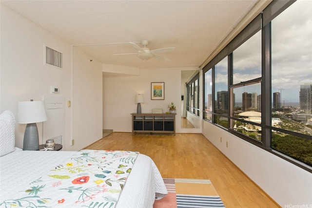 1221 Victoria St Unit 2301, Honolulu, HI 96814 - bedroom with wood finished floors, access to outside, and ceiling fan