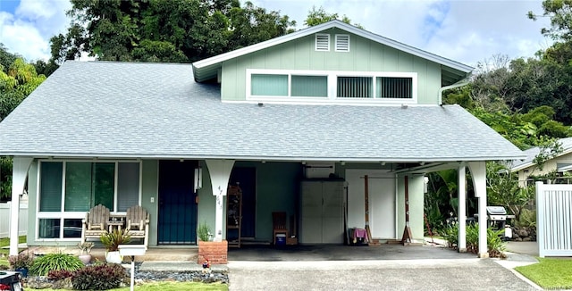 47-643 Hui Ulili St, Kaneohe, HI 96744 - view of front facade featuring roof with shingles, driveway, a porch, and a carport
