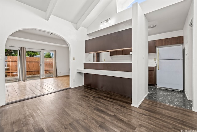94-011 Kuahelani Ave Unit 135, Mililani, HI 96789 - unfurnished living room featuring beamed ceiling, dark wood finished floors, arched walkways, and high vaulted ceiling