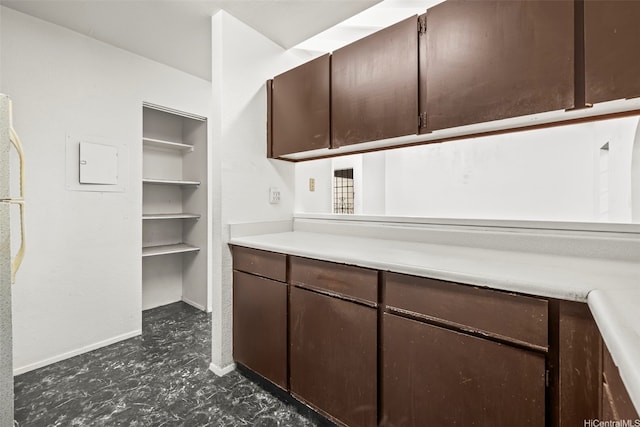 94-011 Kuahelani Ave Unit 135, Mililani, HI 96789 - kitchen with dark brown cabinetry, light countertops, and freestanding refrigerator