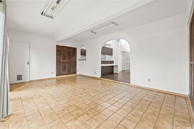 94-011 Kuahelani Ave Unit 135, Mililani, HI 96789 - spare room featuring light tile patterned floors and arched walkways