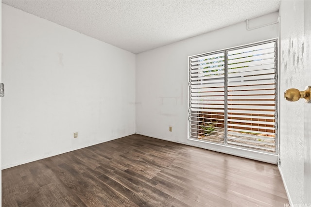 94-011 Kuahelani Ave Unit 135, Mililani, HI 96789 - spare room featuring wood finished floors and a textured ceiling