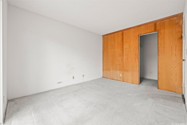94-011 Kuahelani Ave Unit 135, Mililani, HI 96789 - unfurnished bedroom featuring carpet floors and wooden walls