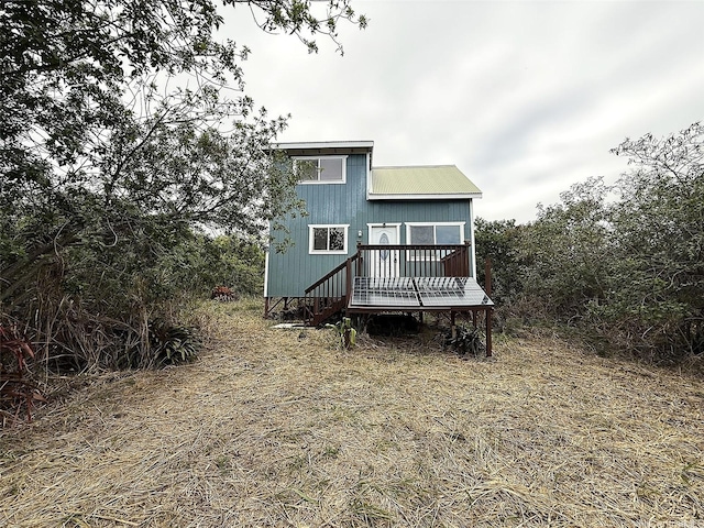 94-6342 Makai St, Naalehu, HI 96772 - back of property with a wooden deck and a metal roof