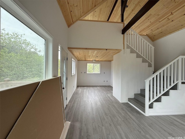 94-6342 Makai St, Naalehu, HI 96772 - interior space with a wooden ceiling with exposed beams, stairs, wood finished floors, and high vaulted ceiling