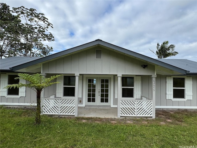 16-2075 Vista Dr, Pahoa, HI 96778 - rear view of property featuring french doors, board and batten siding, and a yard