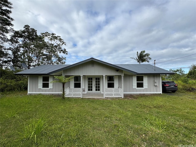 16-2075 Vista Dr, Pahoa, HI 96778 - rear view of property with french doors, board and batten siding, a lawn, and a metal roof