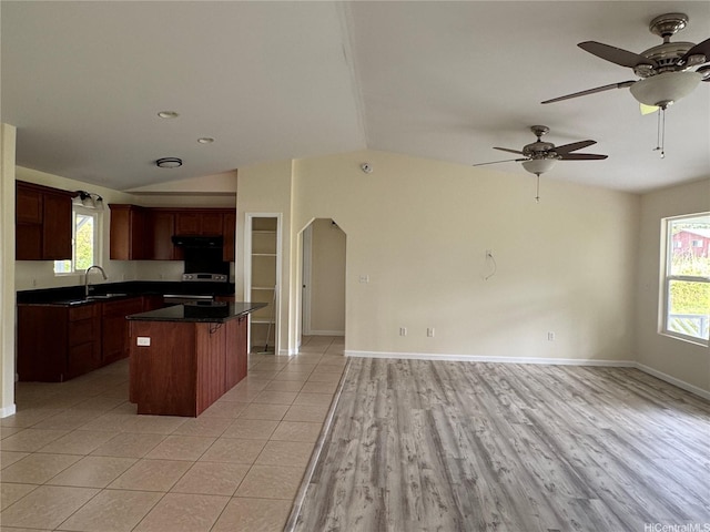 16-2075 Vista Dr, Pahoa, HI 96778 - kitchen featuring electric stove, open floor plan, dark countertops, a kitchen island, and lofted ceiling