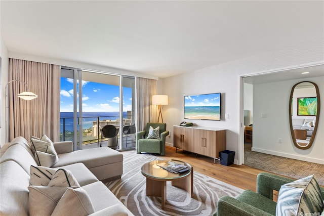 383 Kalaimoku St Unit 3109, Honolulu, HI 96815 - living room with light wood finished floors and a wall of windows