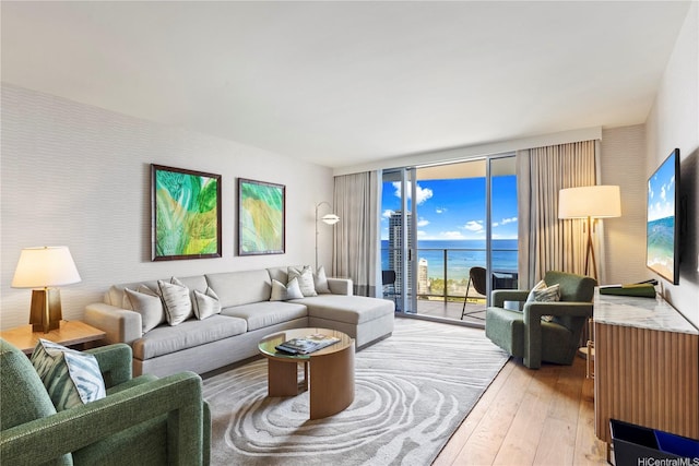 383 Kalaimoku St Unit 3109, Honolulu, HI 96815 - living area with a wall of windows and light wood-style flooring