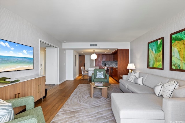 383 Kalaimoku St Unit 3109, Honolulu, HI 96815 - living room featuring dark wood-style floors and baseboards