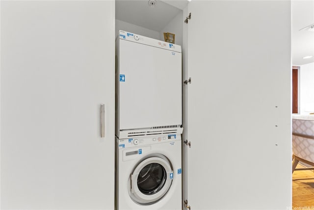 383 Kalaimoku St Unit 3109, Honolulu, HI 96815 - washroom with estacked washer and dryer and wood finished floors