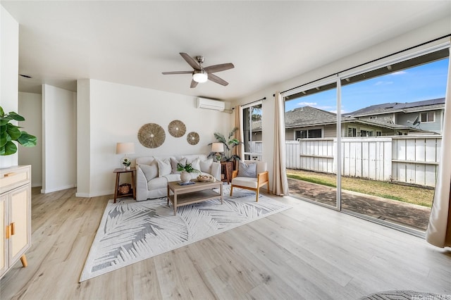 91-1033 Keokolo St Unit B, Kapolei, HI 96707 - living room with light wood-style flooring, ceiling fan, and a wall mounted air conditioner
