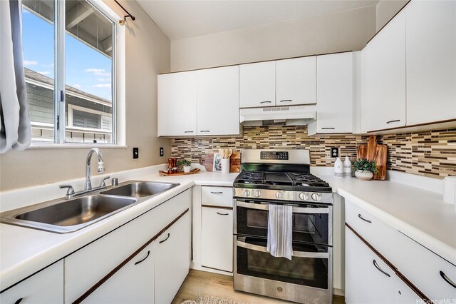 91-1033 Keokolo St Unit B, Kapolei, HI 96707 - kitchen featuring range with two ovens, decorative backsplash, light countertops, and white cabinetry