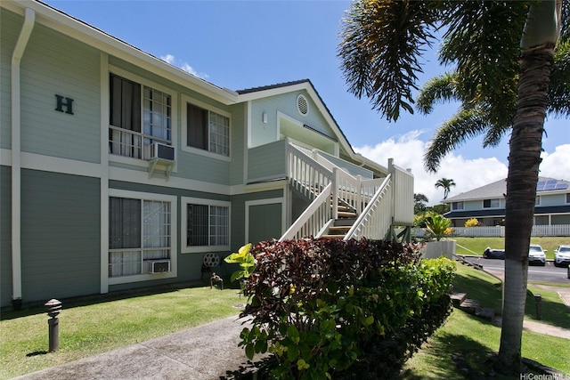 94-1475 Waipio Uka St Unit H206, Waipahu, HI 96797 - view of property exterior featuring stairway, a lawn, and cooling unit