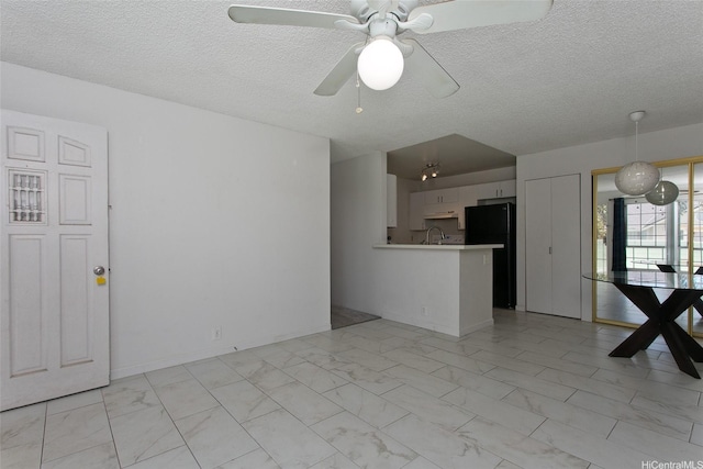 94-1475 Waipio Uka St Unit H206, Waipahu, HI 96797 - unfurnished living room with light marble finish flooring, a textured ceiling, and ceiling fan