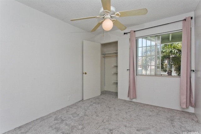 94-1475 Waipio Uka St Unit H206, Waipahu, HI 96797 - unfurnished bedroom featuring carpet flooring, a textured ceiling, ceiling fan, and a closet