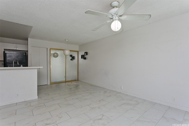 94-1475 Waipio Uka St Unit H206, Waipahu, HI 96797 - unfurnished living room featuring a textured ceiling, ceiling fan, and light marble finish flooring