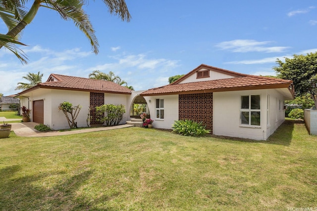 55-439 Naniloa Loop, Laie, HI 96762 - rear view of property with a garage, concrete block siding, a lawn, and a tile roof