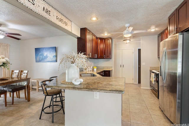 55-439 Naniloa Loop, Laie, HI 96762 - kitchen featuring stainless steel fridge with ice dispenser, ceiling fan, a peninsula, a textured ceiling, and black range with electric cooktop
