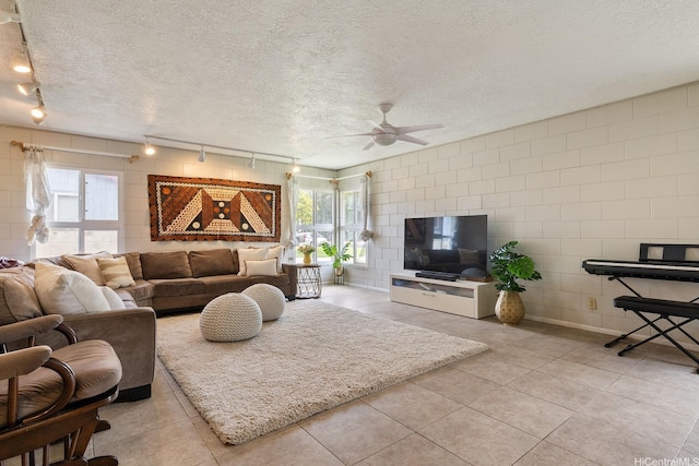 55-439 Naniloa Loop, Laie, HI 96762 - living area with track lighting, ceiling fan, plenty of natural light, light tile patterned flooring, and a textured ceiling