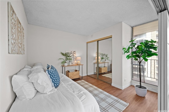 2754 Kuilei St Unit 1601, Honolulu, HI 96826 - bedroom with wood finished floors, a textured ceiling, and a closet