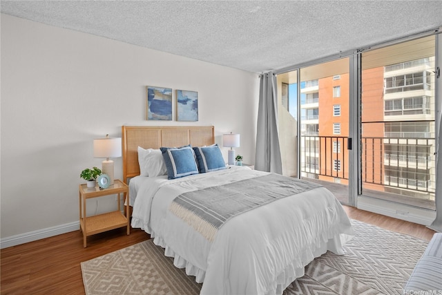 2754 Kuilei St Unit 1601, Honolulu, HI 96826 - bedroom featuring expansive windows, access to exterior, wood finished floors, and a textured ceiling