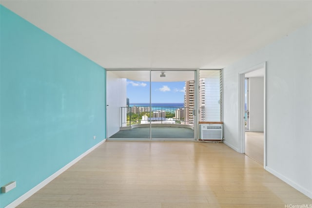 469 Ena Rd Unit 3208, Honolulu, HI 96815 - empty room featuring expansive windows, wood finished floors, and a water view