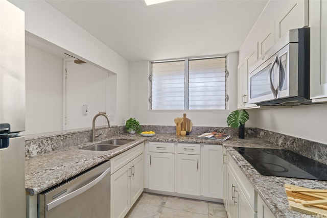 469 Ena Rd Unit 3208, Honolulu, HI 96815 - kitchen with stainless steel appliances, light stone countertops, white cabinets, and light tile patterned floors