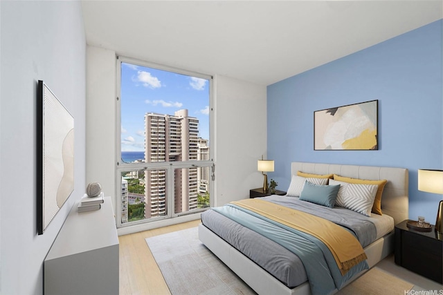 469 Ena Rd Unit 3208, Honolulu, HI 96815 - bedroom featuring expansive windows, wood finished floors, multiple windows, and a city view
