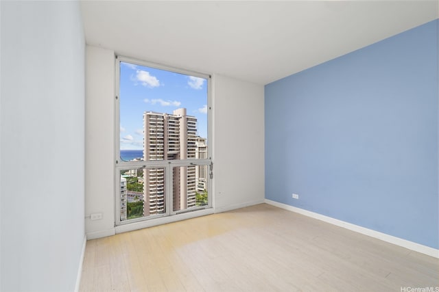 469 Ena Rd Unit 3208, Honolulu, HI 96815 - unfurnished room with wood finished floors, floor to ceiling windows, and a water view
