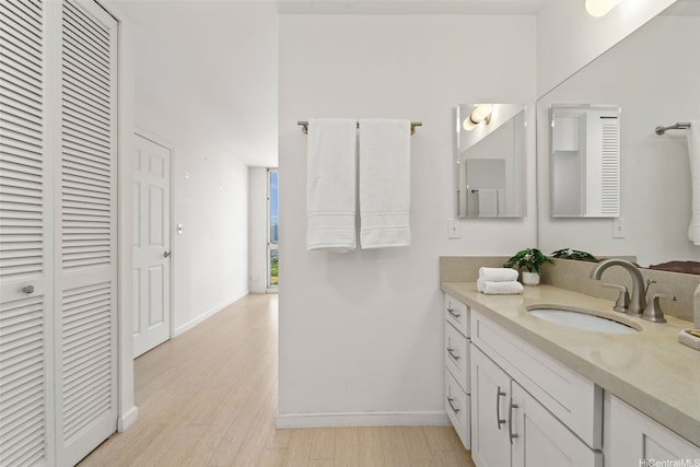 469 Ena Rd Unit 3208, Honolulu, HI 96815 - bathroom with a closet, vanity, and wood finished floors