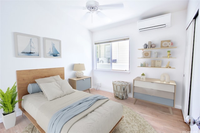 94-1043 Alelo St, Waipahu, HI 96797 - bedroom featuring a wall mounted air conditioner, light wood-style flooring, ceiling fan, and a closet