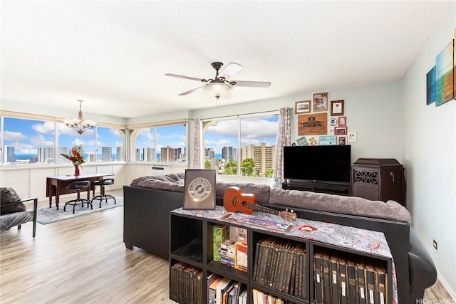 1022 Prospect St Unit 704A, Honolulu, HI 96822 - living room featuring wood finished floors, a chandelier, and a ceiling fan